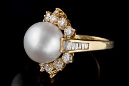A large cultured pearl and diamond cluster ring: with central cultured pearl 14mm diameter within a