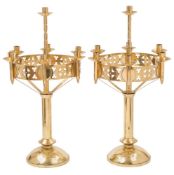 A pair of Arts and Crafts Gothic revival candelabra: the plain central column with single nozzle