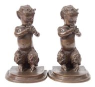 Brenda Putnam (1890-1975) A pair of bronze bookends: depicting satyrs playing pan pipes,