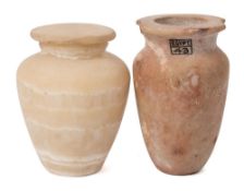 An Egyptian limestone jar: of tapering form on a flat base(rim damaged);