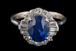 A fine sapphire and diamond oval cluster ring: with central oval sapphire 9.2mm long x 6.