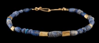 A gold and lapis lazuli bead single-string bracelet.
