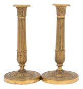 A pair of late 19th century gilt brass French candlesticks: with acanthus decorated capitals on