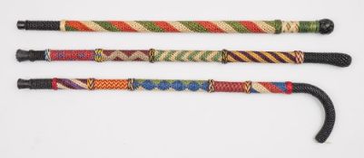 Ray Tucknott, two multicoloured ropework walking canes and a walking stick:.