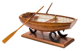 A clinker built model of a dinghy:, with ribbed varnished hull,