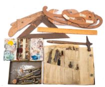 A collection of geometry sets, paint tin, French curves,