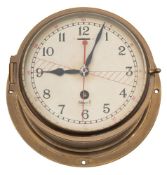A brass cased radio room bulkhead clock by Mercer:,