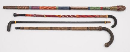 Ray Tucknott, two multicoloured ropework walking canes and two other ropework walking sticks:.