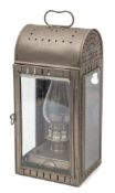 A bulkhead lamp:, with arched top and bevelled glass enclosing an oil lamp, 48cm high.