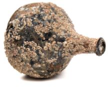 An 18th century wine bottle in salvaged condition circa 1740:, of onion form with raised neck,
