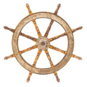 A teak and iron ship's helm:, unsigned, of typical form with iron boss and banded rim,