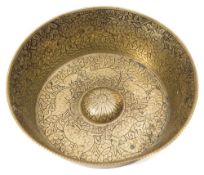 An Islamic engraved brass bowl: with flared sides and central boss to the interior,