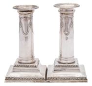 A pair of Edward VII silver neo-classical silver candlesticks, maker Thomas Bradbury & Sons, London,
