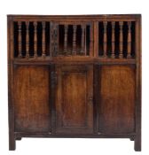 A French oak fruit hutch: with spindle inset doors above cupboard doors below,