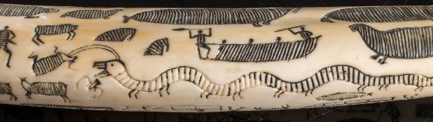 A late 19th/early 20th century Inuit carved walrus tusk:, unsigned,