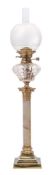 A late Victorian brass and onyx oil lamp: with clear cut glass reservoir,