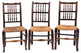 A harlequin set of six early 19th Century ash and fruitwood spindle back dining chairs:,