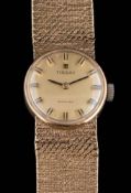 A lady's 9ct gold 'Tissot' wristwatch: the dial with baton makers and on mesh-link strap,