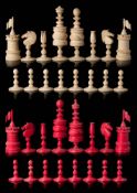 A 19th century bone Barleycorn pattern chess set: one side stained red, the other left natural,