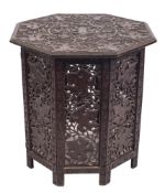 An Indian carved hardwood octagonal centre table,: on a hinged base,