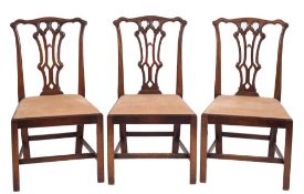 A set of six carved mahogany dining chairs in the Chippendale taste:,