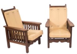 An Arts and Crafts oak three piece suite: comprising a twin seat settee and a pair of armchairs,