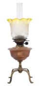 An Arts and Crafts copper and brass oil lamp by Benson: the copper reservoir raised on a knopped
