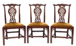 A set of six George III carved mahogany dining chairs:, in the Chippendale taste,