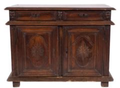 An 18th Century French Provincial carved walnut side cupboard:, with a rectangular moulded top,