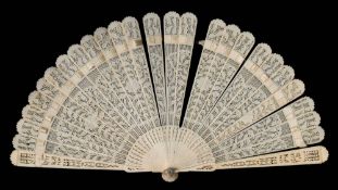 A 19th century ivory brise fan: with pierced foliate decoration to the leaf and guards, 17cm. long.