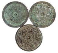 A Chinese bronze mirror: of archaic circular form decorated with mythical animals, 13cm.
