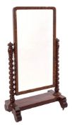 A Victorian mahogany swing frame cheval mirror:, the rectangular plate in bevelled surround,