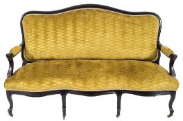 A carved and ebonised frame canape:, in the French taste,
