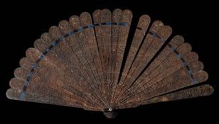 A 19th century Chinese tortoiseshell brise fan: carved to one side with flowers and pierced