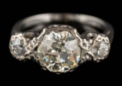 An illusion-set diamond three-stone ring: the principal round old-cut diamond approximately 8.