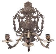 A Continental bronze three-branch wall applique: the pierced backplate of arched outline with