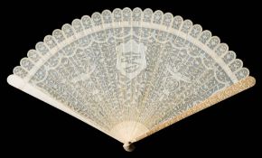 A Cantonese carved ivory brise fan: carved to one side with central shield-shaped cartouche flanked