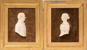 A pair of low relief carved ivory half length busts: believed to be Robert Browning and Elizabeth