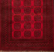 An Afghan carpet of traditional design and colours:,