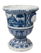 An impressive large French faience jardiniere: of campana form with female mask head handles,