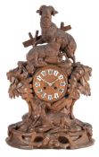 A large 19th century carved Black Forest mantel clock in the form of rams: the eight-day duration