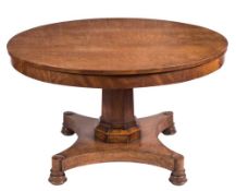 A Victorian mahogany circular breakfast table:, the flame figured snap top on polygonal column,