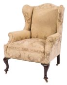 A mahogany wing frame armchair in the Queen Anne taste:,