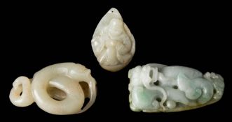 A Chinese carved jade pendant: of triangular outline with a seated figure wearing robes, 4.5cm.