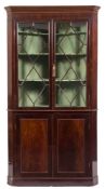 A 19th century mahogany standing corner display cabinet,: the upper part with a moulded cornice,