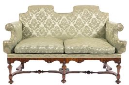 A walnut and crossbanded frame twin seat settee in the William and Mary taste,