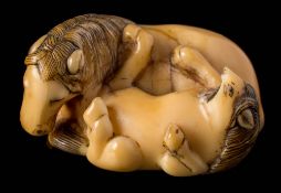 A Japanese ivory netsuke: naturalistically carved as a recumbent horse and foal, Meiji, 3.