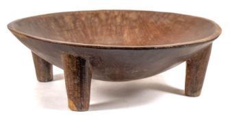 A Fijian Yaqona bowl: the plain circular bowl raised on four tapering legs,