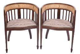 A pair of Edwardian mahogany and inlaid tub shaped occasional armchairs: bordered with boxwood