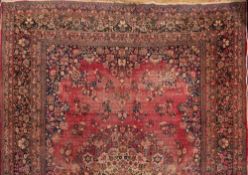An Iranian carpet,: the wine field with a central arabesque floral medallion,